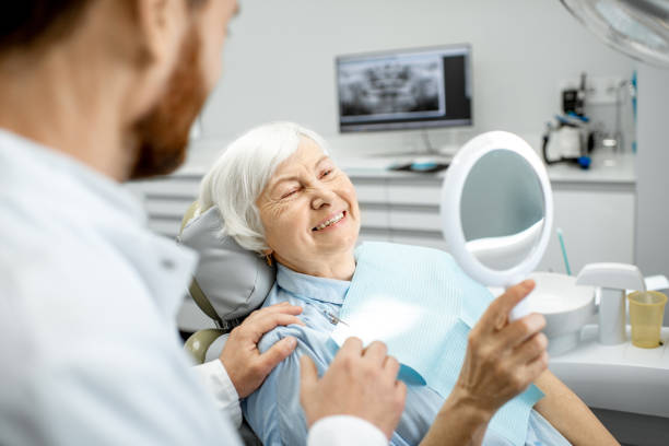 Happy elderly woman at the dentist